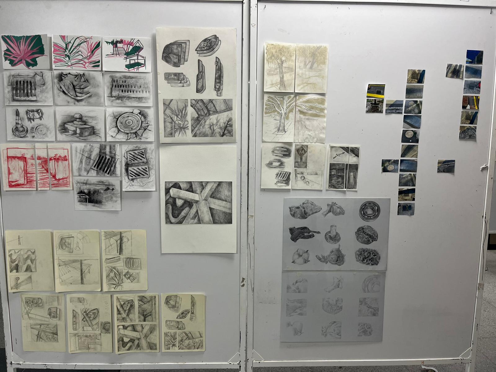 Sketches and drawings arranged on a studio board.